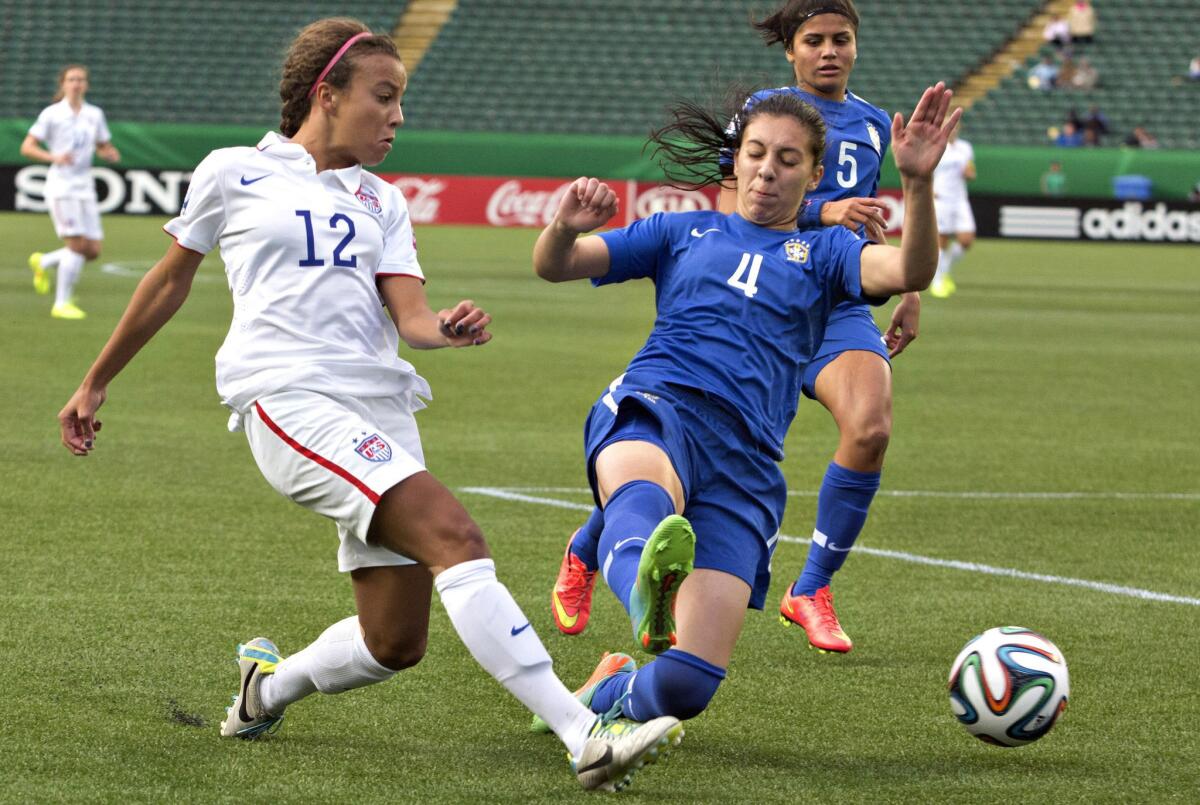 Mallory Pugh of the United States gets to the ball ahead of Julia Bianchi of Brazil during the first half of a U-20 FIFA women's World Cup soccer game on Aug. 8, 2014.