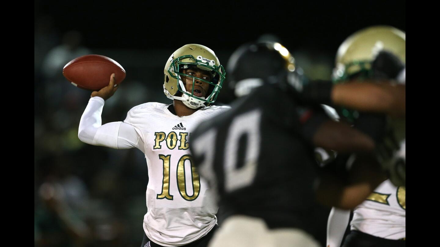Long Beach Poly quarterback Nolan McDonald eludes Narbonne rushers to attempt a pass on Thursday night at Narbonne High.