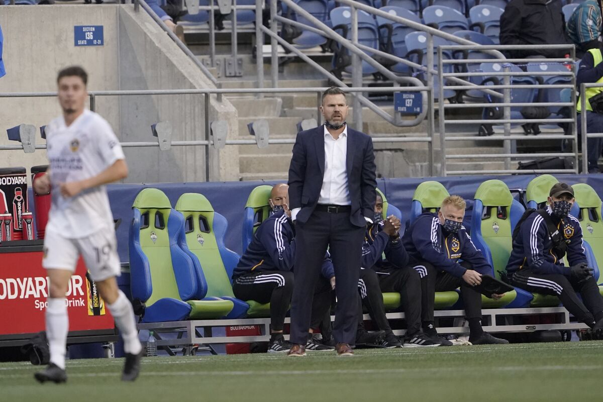 Galaxy head coach Greg Vanney watches from the bench during a match against the Seattle Sounders