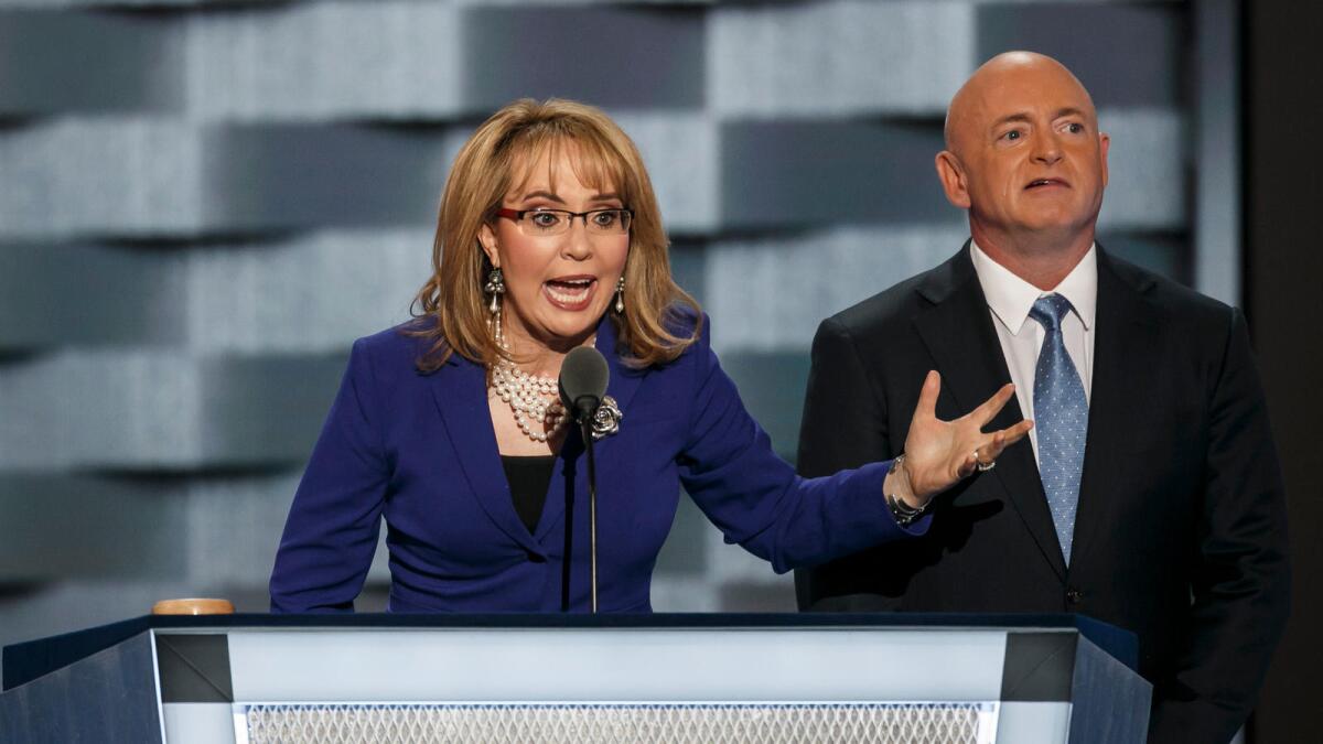 Former U.S. Rep. Gabrielle Giffords of Arizona speaks at the Democratic National Convention alongside her husband, Mark E. Kelly, in July.