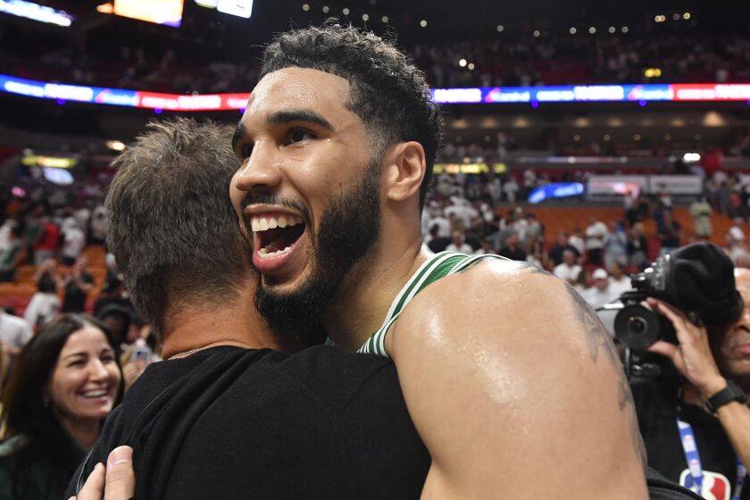 Boston Celtics forward Jayson Tatum celebrates after the Celtics beat the Miami Heat 104-103 during Game 6 of the NBA basketball Eastern Conference finals, Saturday, May 27, 2023, in Miami. (AP Photo/Michael Laughlin)