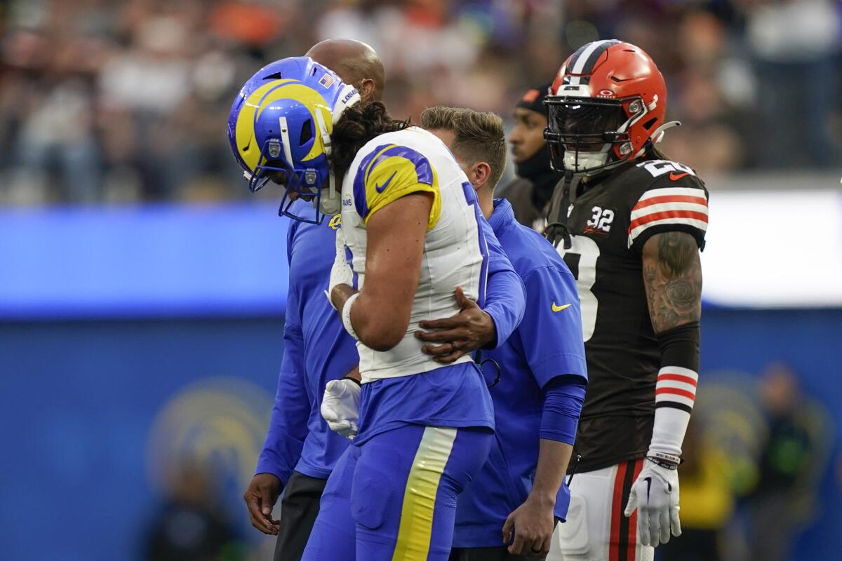 Rams wide receiver Puka Nacua is helped off the field after sustaining an injury against the Browns in the second quarter.