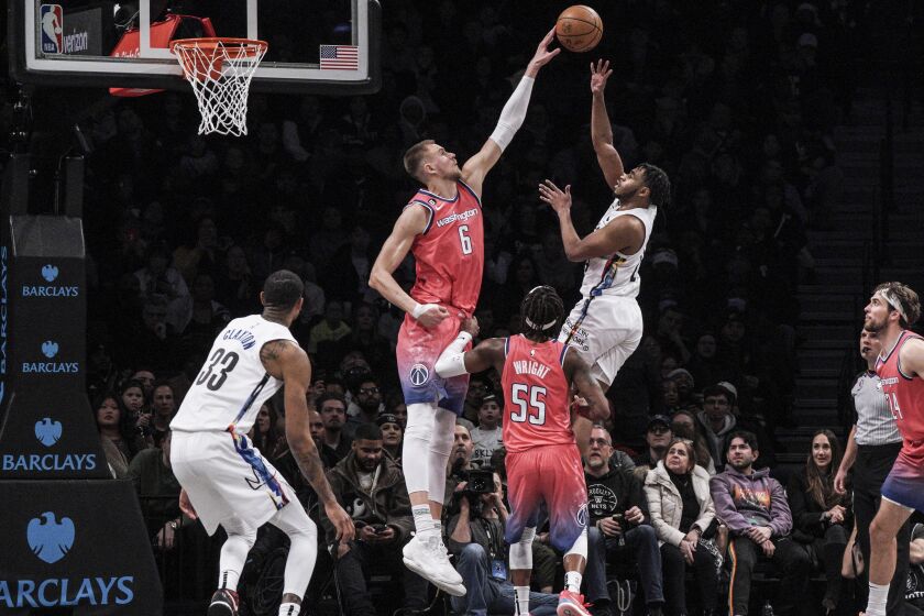 Washington Wizards center Kristaps Porzingis, second from left, attempts to block Brooklyn Nets guard Cam Thomas, during the second half of an NBA basketball game, Saturday, Feb. 4, 2023, in New York. (AP Photo/Bebeto Matthews)