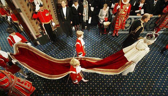 Britain's Queen Elizabeth II and Prince Philip make their way in the Palace of Westminster en route to the House of Lords for her annual speech at the opening of Parliament in London. The Palace of Westminster is home to the Houses of Parliament.