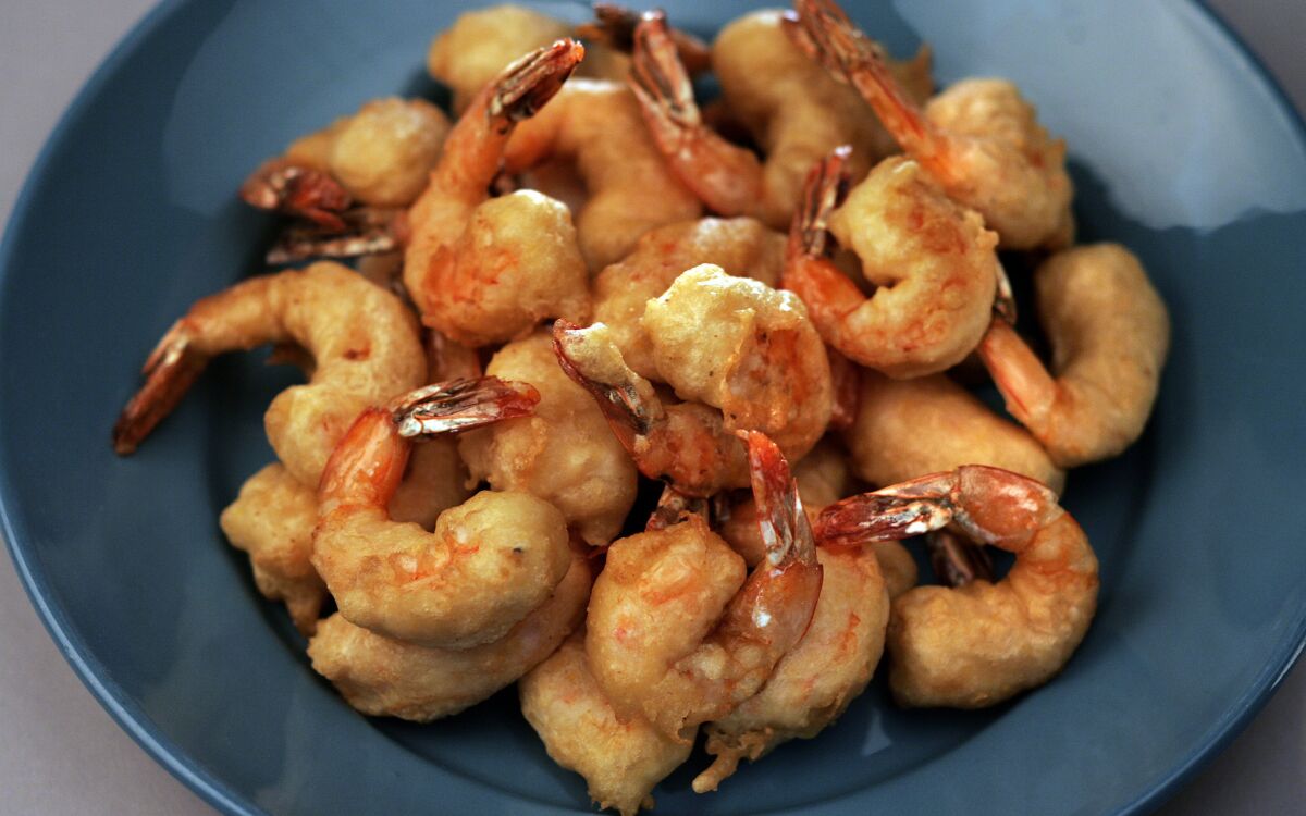 Beer-battered shrimp piled on a plate