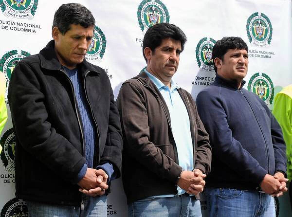 Jose Fernando Lopesierra, left, and brothers Diego and Enrique Baez are presented to the media in Bogota in March 2011. The brothers' criminal organization smuggled an average of 5 tons of cocaine a month to Central America and Mexico, U.S. law enforcement sources say.