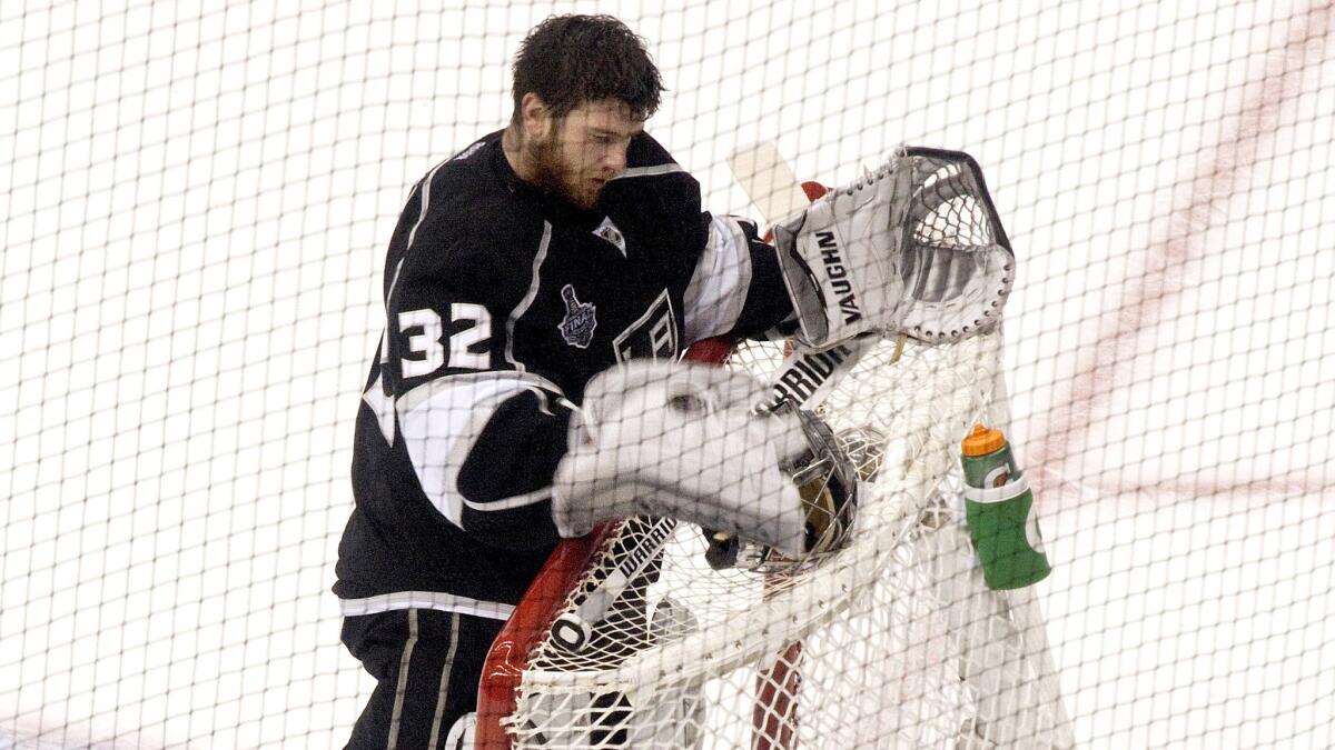 Kings goaltender Jonathan Quick gathers himself after losing his mask during an interference penalty in Game 5 of the Stanley Cup playoffs on June 13, 2014.