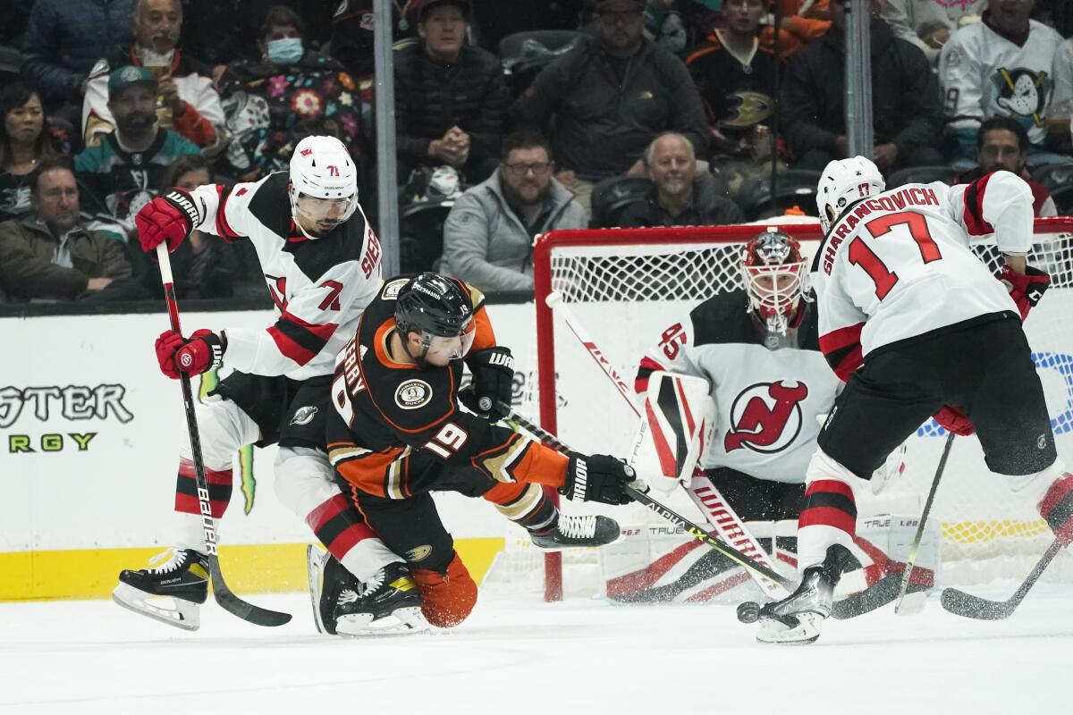 New Jersey Devils goaltender Jonathan Bernier guards his net as the Ducks' Troy Terry shoots under pressure.