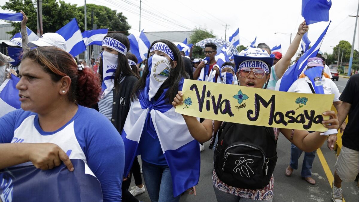 Demonstrators demand the resignation of President Daniel Ortega and the release of political prisoners in Managua, Nicaragua, on July 22. The sign, which reads "Long live Masaya," refers to the city of Masaya, considered an opposition stronghold.