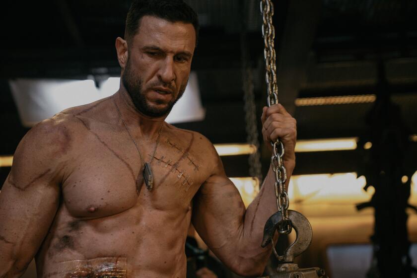 A very muscular man shirtless, with bruises, dirt and scars on his body.