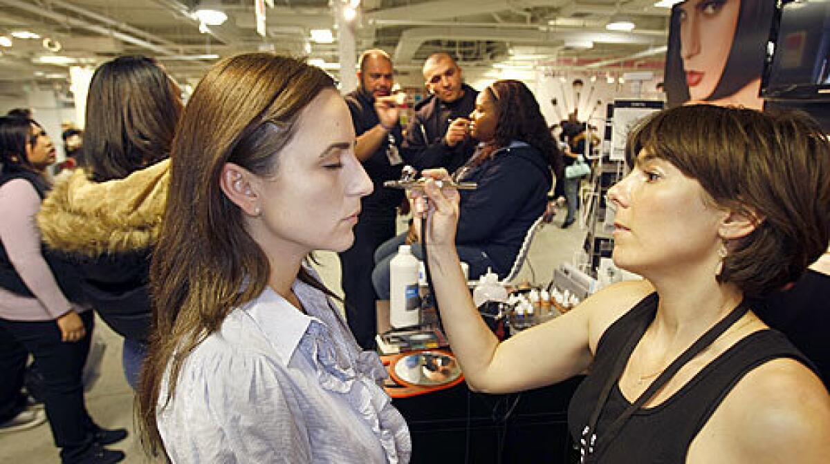 SMOOTH LOOK: Noelle LoPorto has makeup applied with an airbrush by artist Laura Reynolds at the Temptu booth at the Makeup Show L.A. trade show.