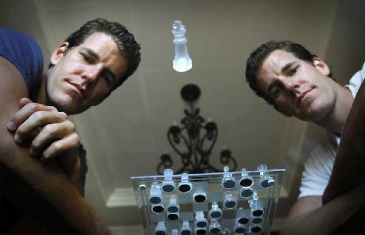 Tyler, left, and Cameron Winklevoss are big supporters of digital currency Bitcoin.