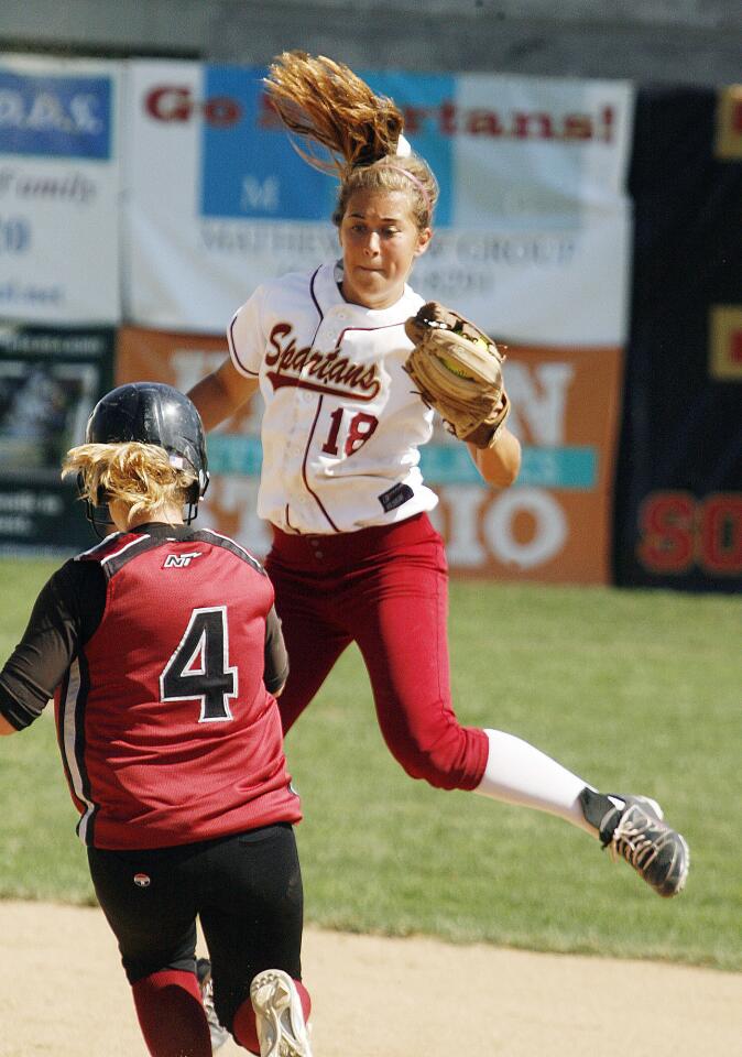 La Canada shortstop Annie Monroe jumps for a high throw from home to catch Nipomo's Abby Trismen stealing in the third inning in a CIF Southern Section Division V semifinal playoff game at La Canada High School.
