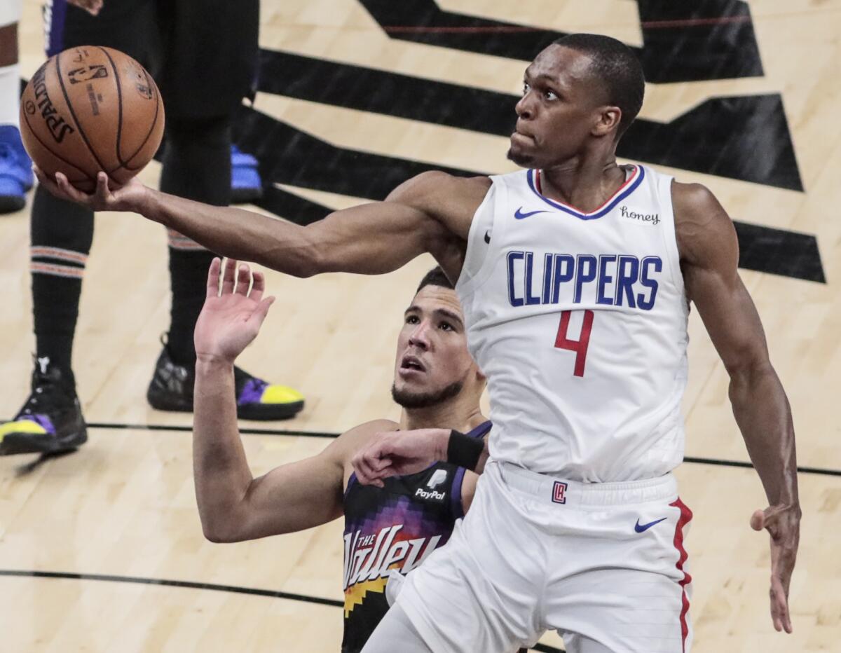 Clippers guard Rajon Rondo attempts a layup.