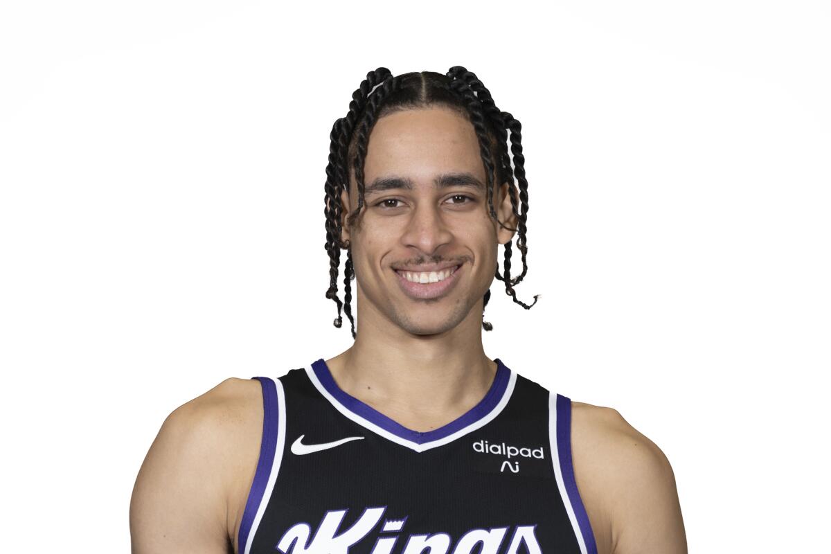 A basketball player in a black Kings jersey.