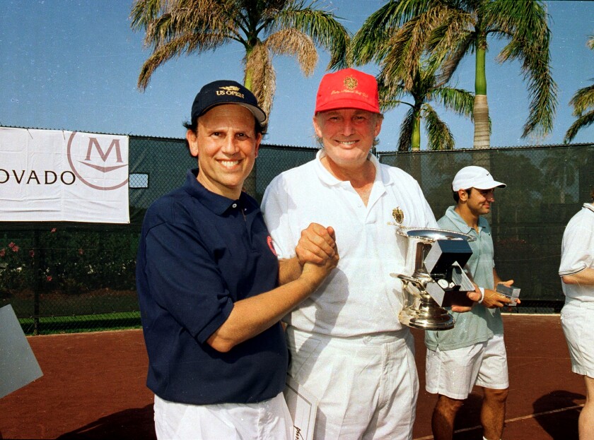 Michael Milken, left, and Donald Trump at a tennis tournament in Palm Beach, Fla., in 2000.