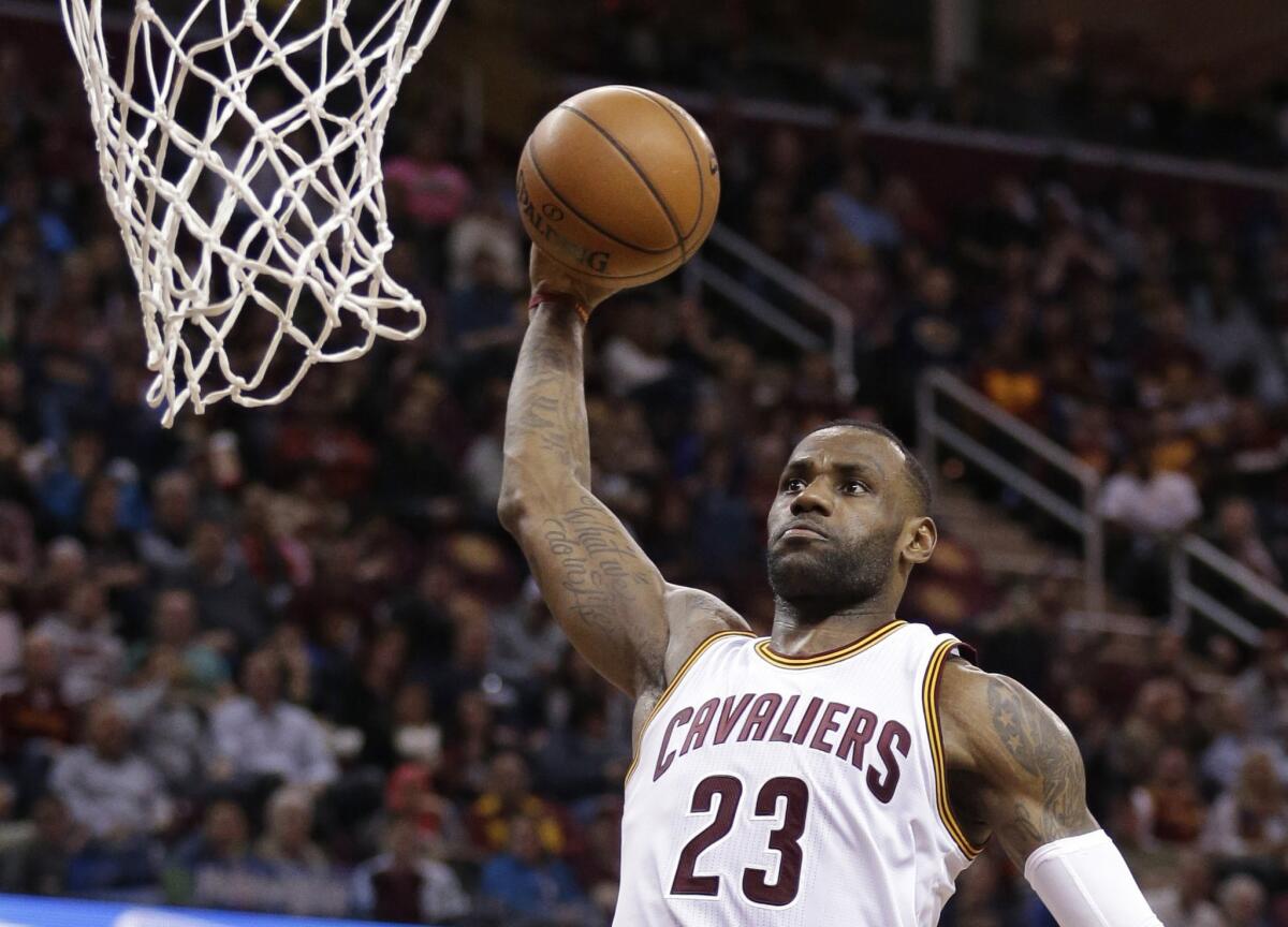 Cavaliers forward LeBron James dunks the ball against the Sacramento Kings in the first half.