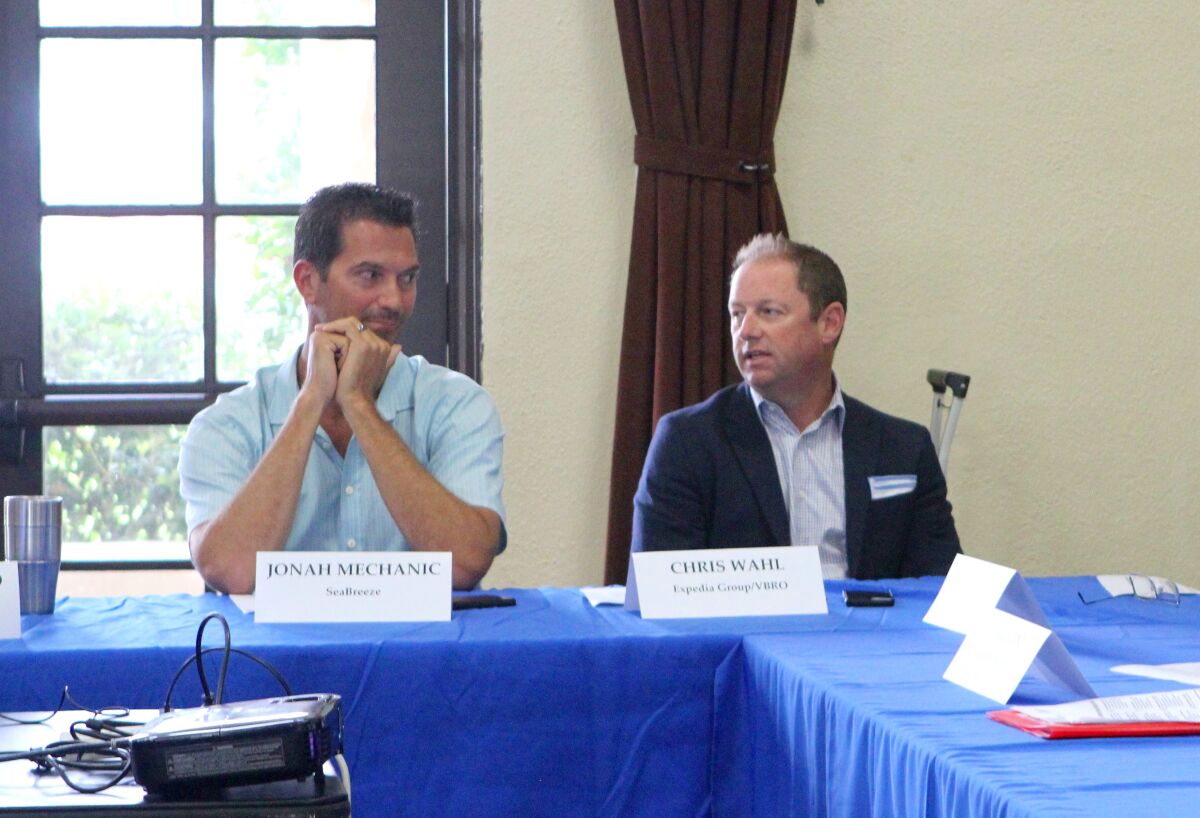 Southwest Strategies lobbyist Christopher Wahl talks with Jonah Mechanic at a La Jolla Town Council meeting in 2019.