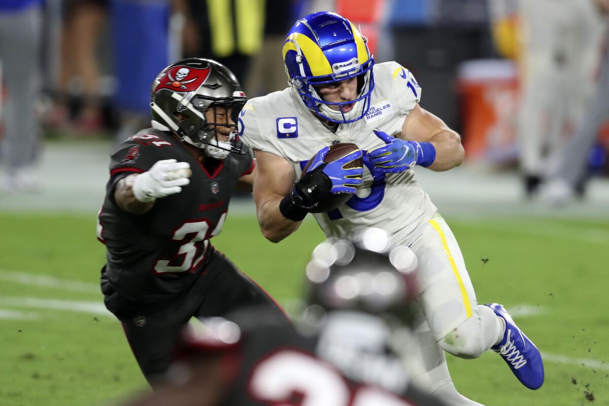 Rams wide receiver Cooper Kupp, right, eludes a tackle by Tampa Bay Buccaneers strong safety Antoine Winfield Jr.