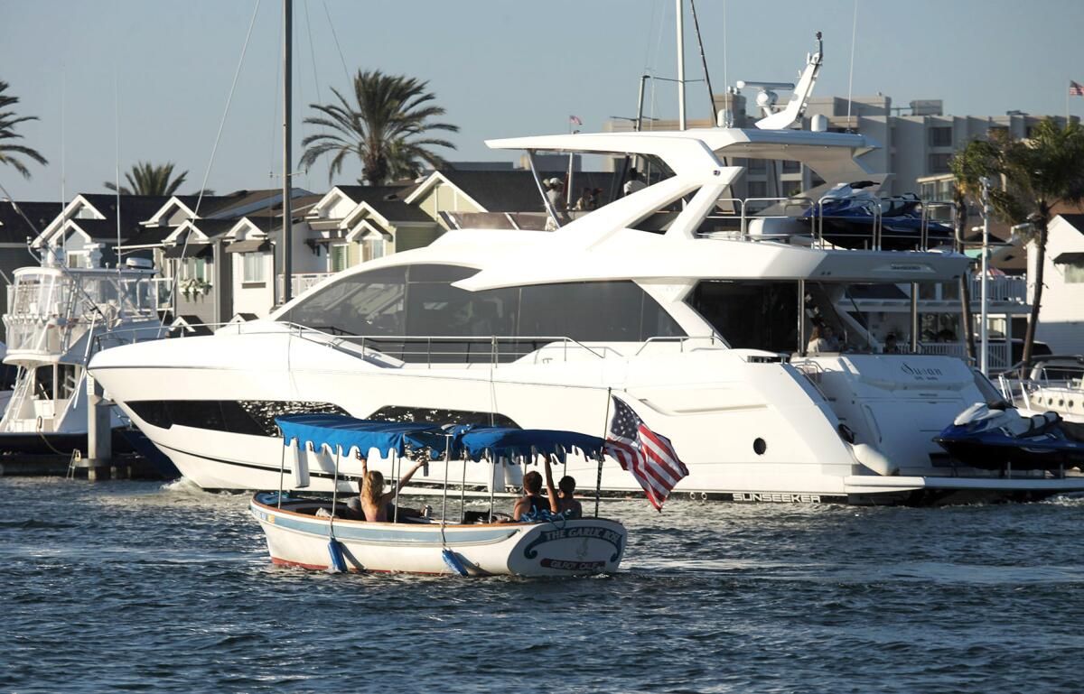 Small boats and yachts cruise together in the 2021 War Heroes on Water Boat Parade.