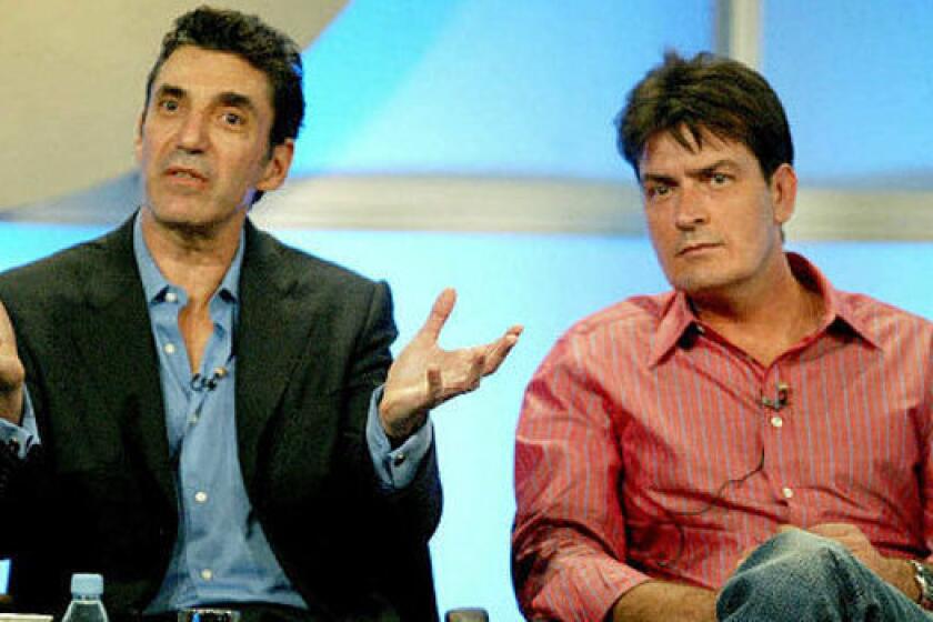 Chuck Lorre, left, and Charlie Sheen are shown during their time working together on "Two and a Half Men."