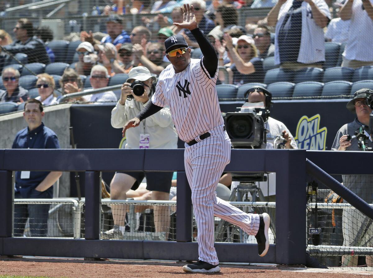 Marcus Thames waves to fans at Yankee Stadium.