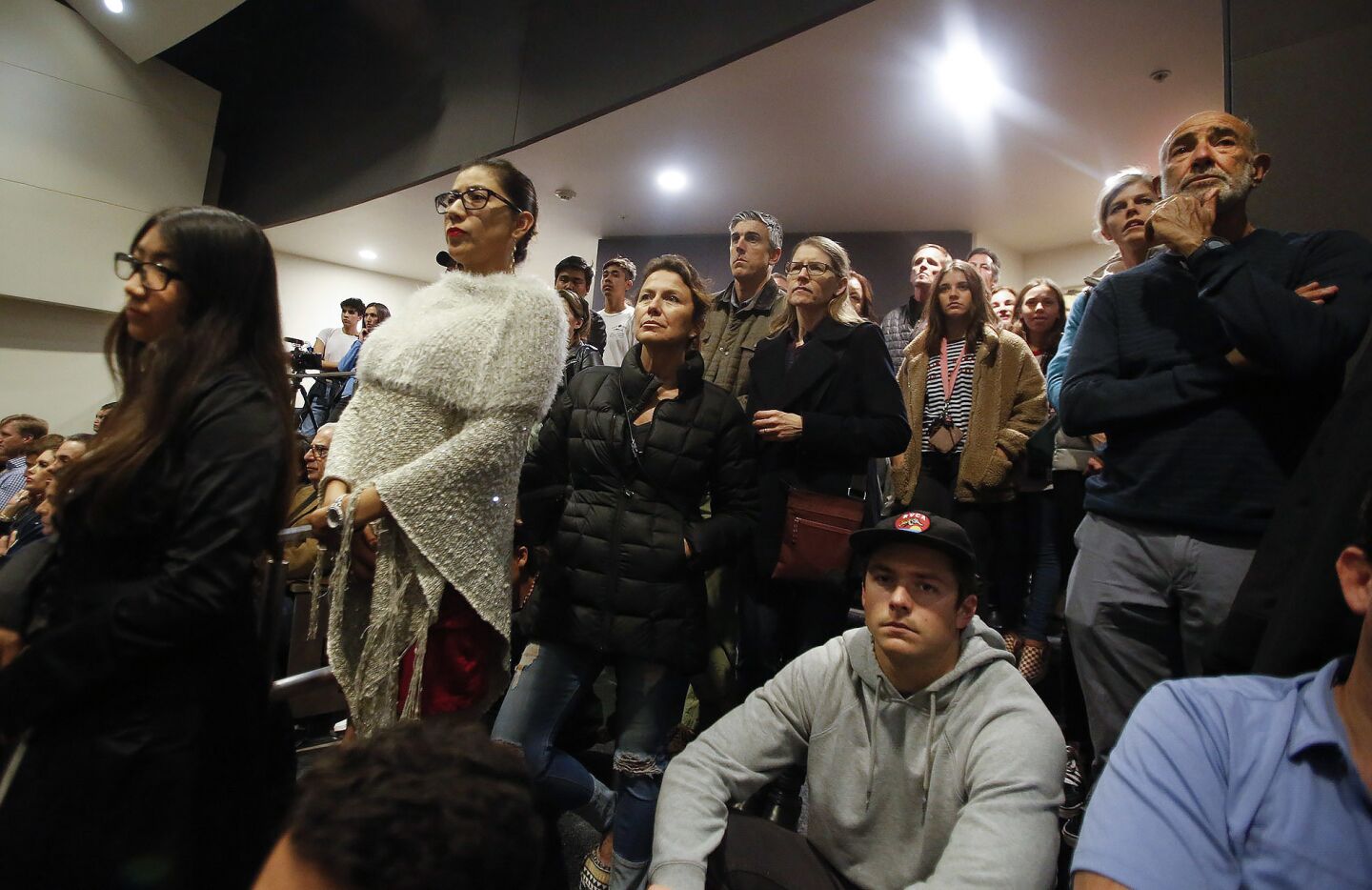Students, parents and other members of the community listen to a town hall-style discussion Monday night at Newport Harbor High School concerning pictures that emerged from an off-campus party that showed students saluting a swastika made of red cups.