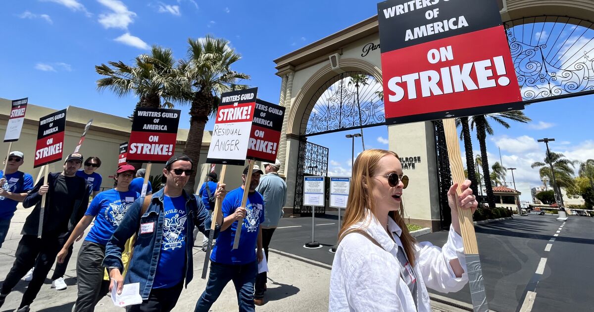 Writers strike: Hollywood scribes picket studios for better pay. 'It's not sustainable'