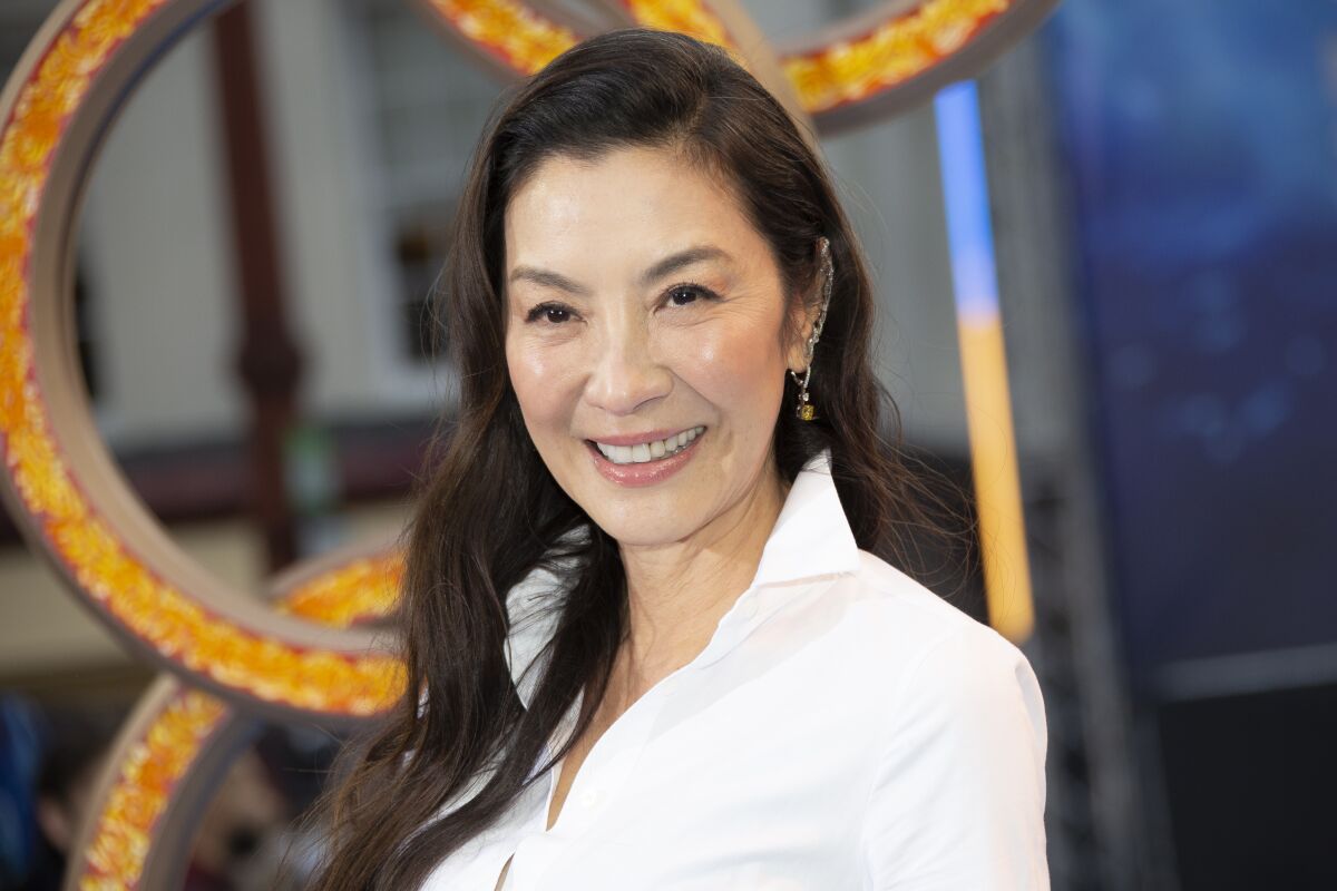 FILE - Michelle Yeoh appears at the premiere of "Shang-Chi and the Legend of the Ten Rings," in West London on Aug 26, 2021. Yeoh stars in the genre-twisting “Everything Everywhere All At Once" playing an Asian immigrant wife and mother trying to be everything for everyone. (Photo by Joel C Ryan/Invision/AP, File)