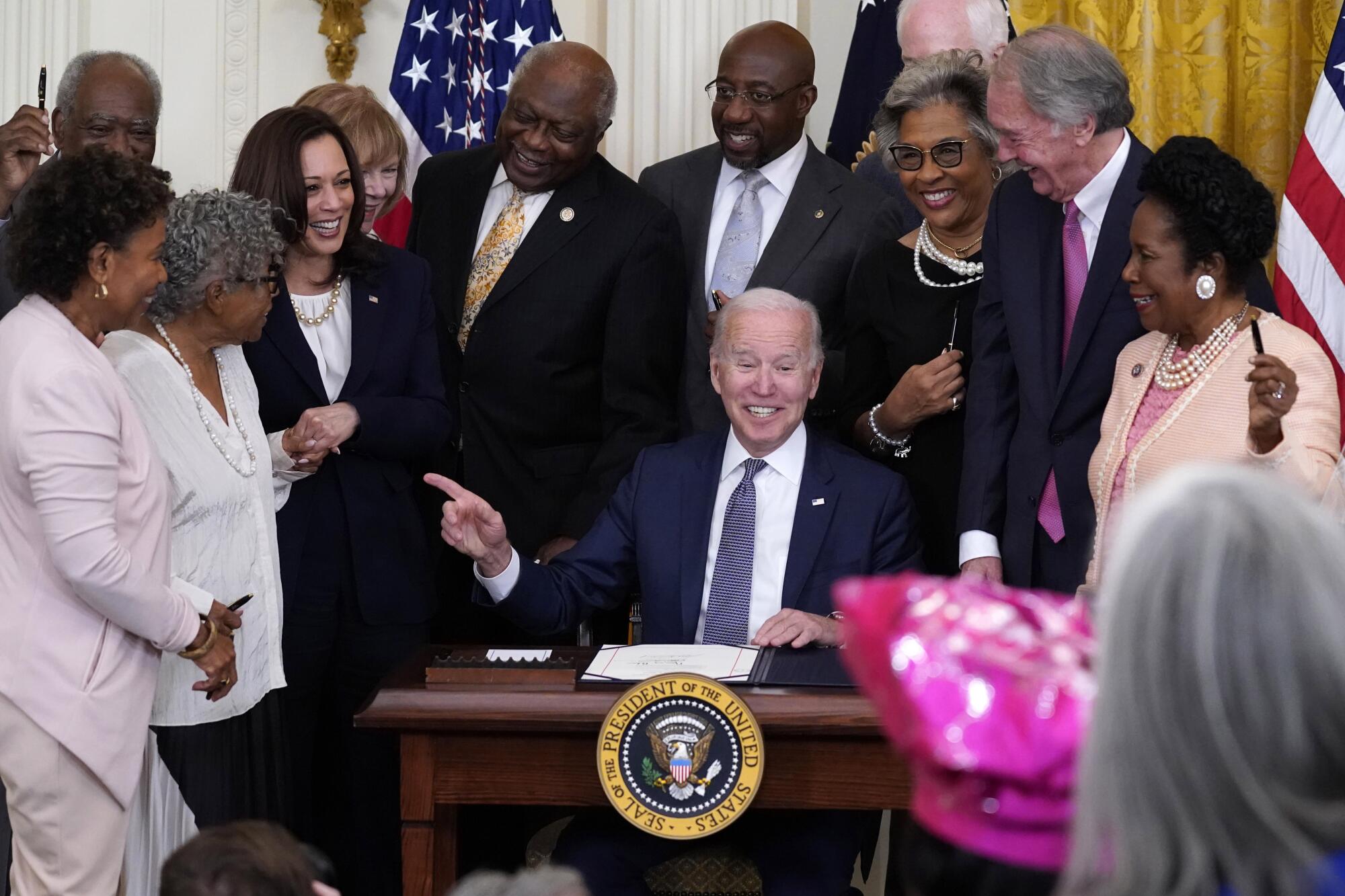 President Biden, surrounded by activist Opal Lee and a number of members of Congress
