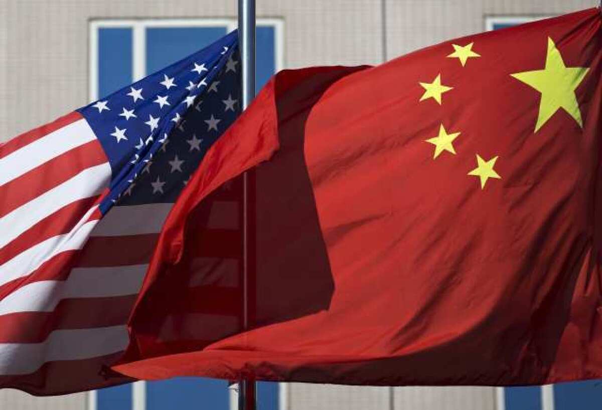 The U.S. flag and China's flag flutter in winds in Beijing during a visit to China by Secretary of State Hillary Clinton earlier this month.