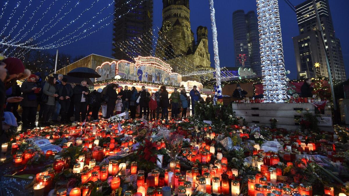 Candles illuminate the scenery at the reopened Christmas Market in Berlin, where on Dec. 19, 2016, an assailant drove a truck into a crowd. (Rainer Jensen / European Press Agency)