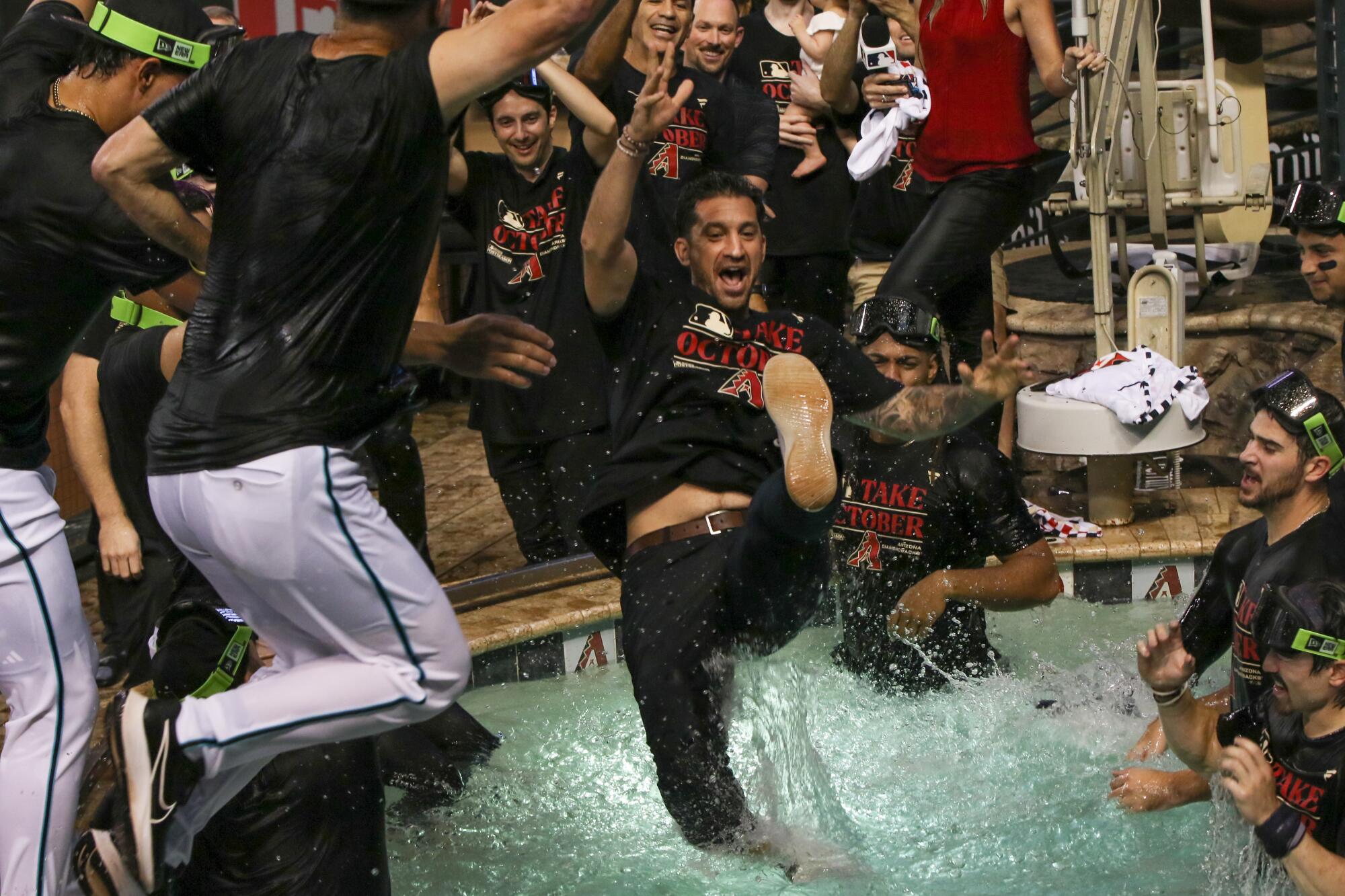 General manager Mike Hazen jumps into the pool after the Arizona Diamondbacks clinched a playoff spot on Sept. 30, 2023.