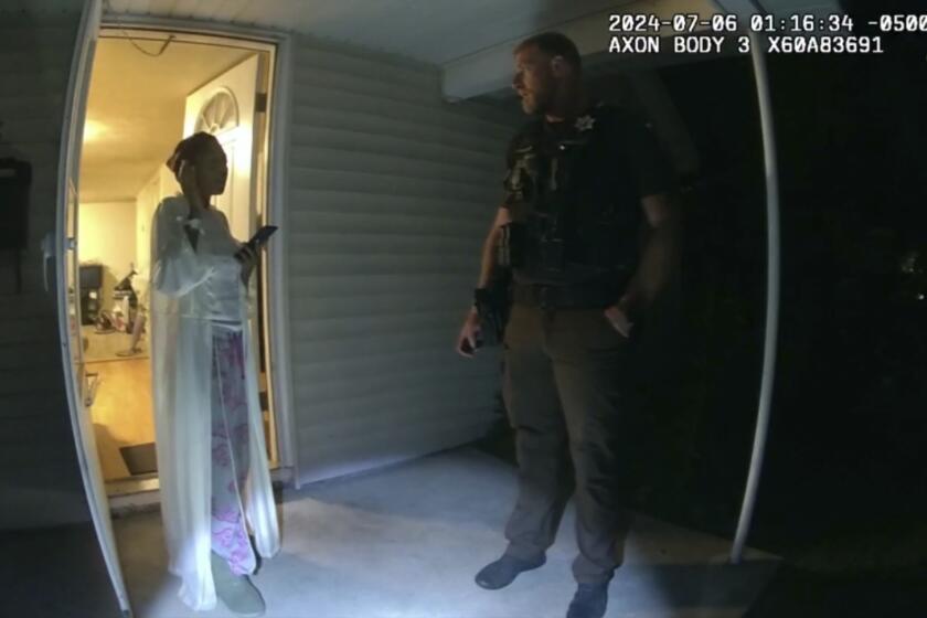 In this image taken from body camera video released by Illinois State Police, Sonya Massey, left, talks with former Sangamon County Sheriff’s Deputy Sean Grayson outside her home in Springfield, Ill., July 6, 2024. Footage released Monday, July 22, by a prosecutor reveals a chaotic scene in which Massey, who called 911 for help, is shot in the face in her home by Grayson. (Illinois State Police via AP)