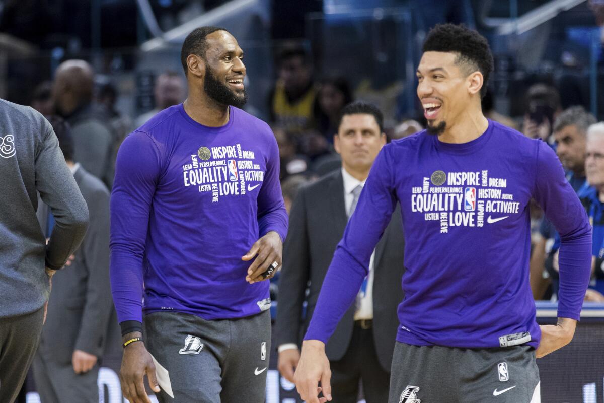 Lakers forward LeBron James, left, and guard Danny Green take part in warmups before a game against the Warriors on Feb. 8.