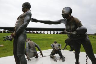 Part of a statue depicting chained people is on display at the National Memorial for Peace and Justice, a new memorial to honor thousands of people killed in racist lynchings, Sunday, April 22, 2018, in Montgomery, Ala. The national memorial aims to teach about America's past in hope of promoting understanding and healing. It's scheduled to open on Thursday. (AP Photo/Brynn Anderson)