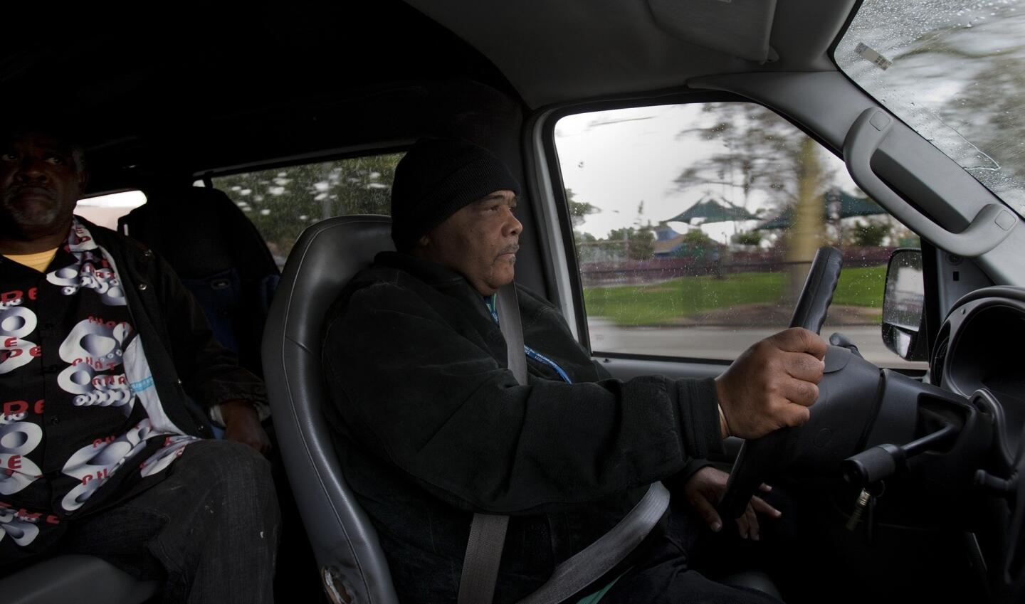 Calvin Woodard drives a patient home after an appointment at the To Help Everyone (T.H.E.) Clinic in South Los Angeles. Many of his riders don't have cars -- or the gas to fill them -- and prefer Woodard's door-to-door service over waiting for a bus.