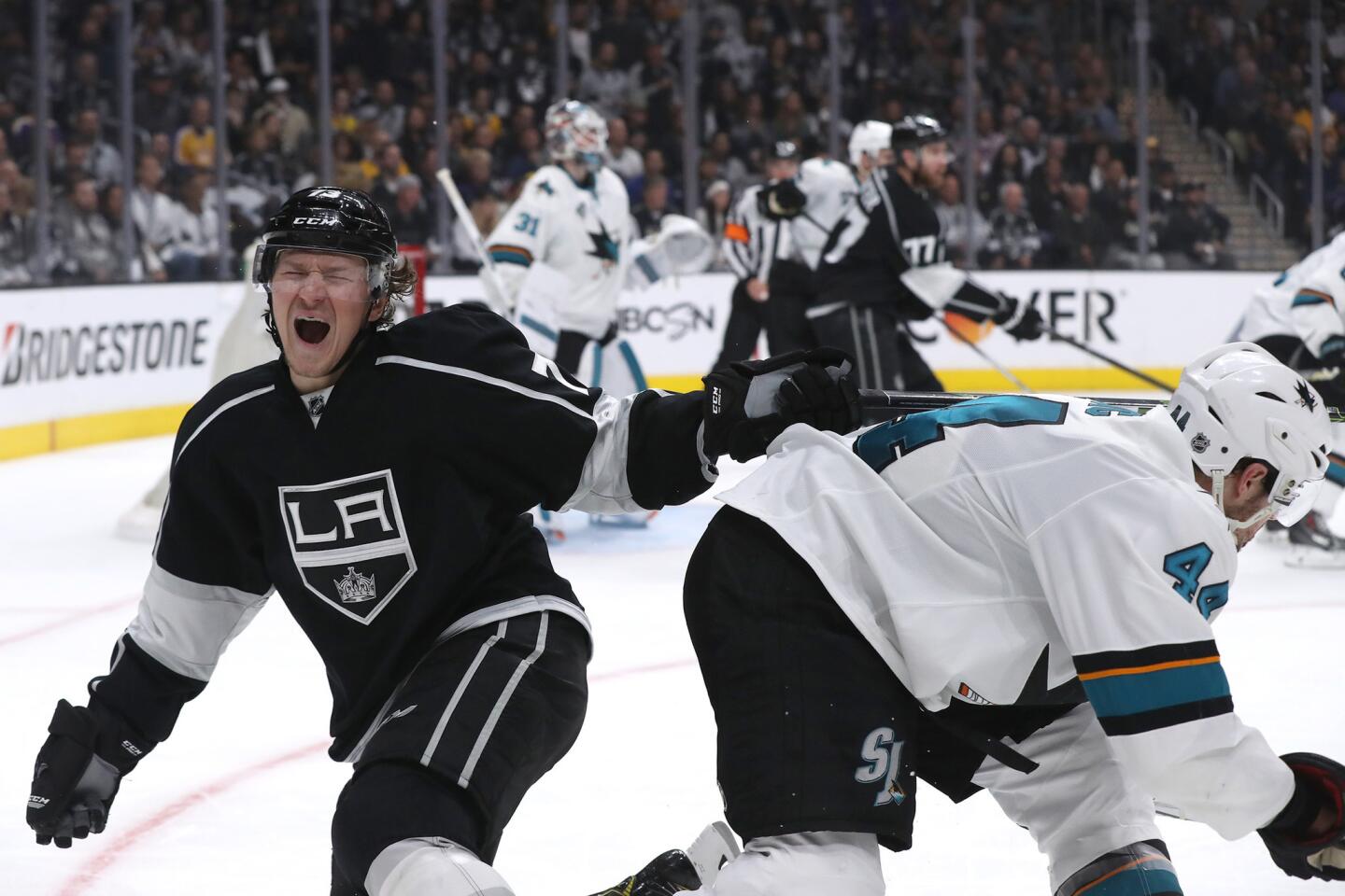 Kings forward Tyler Toffoli grimaces in pain after colliding with Sharks defenseman Marc-Edouard Vlasic during the third period of a game on April 22.