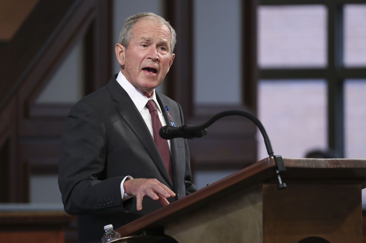 George W. Bush speaks at a lectern