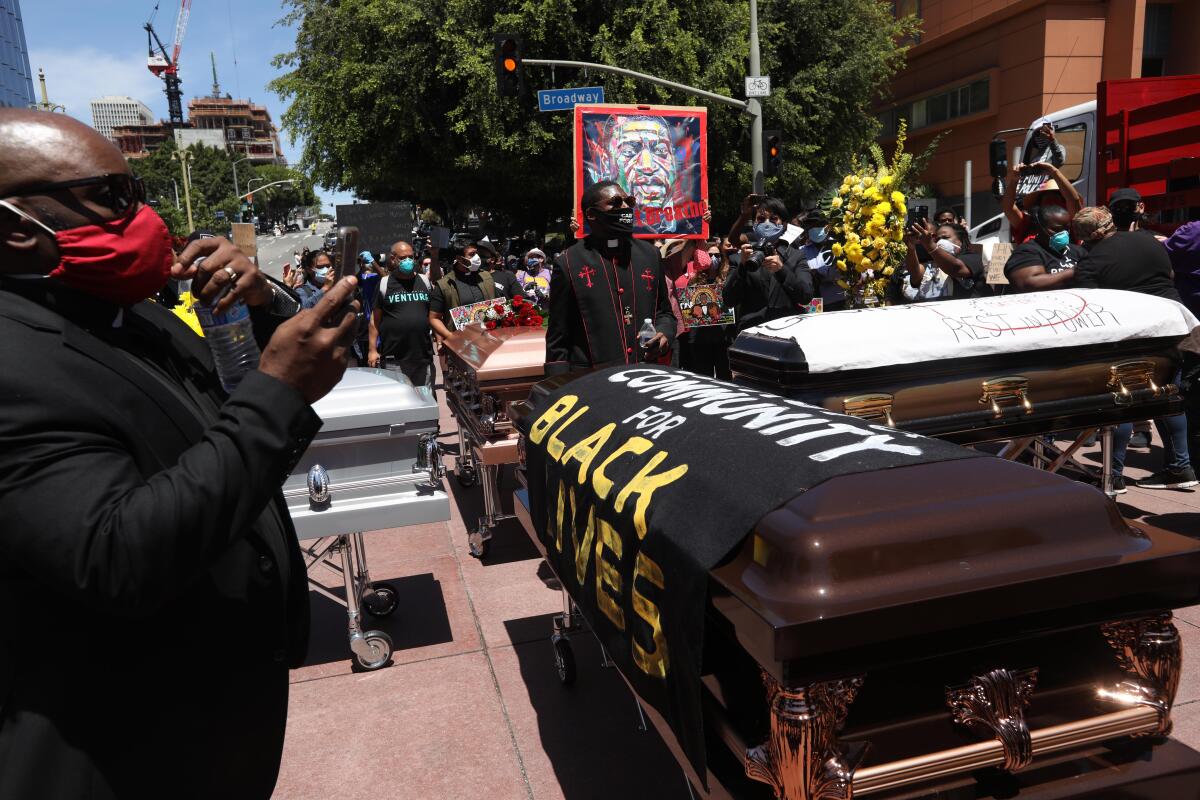 Hundreds attend a memorial service and funeral procession honoring George Floyd on Monday in Los Angeles.