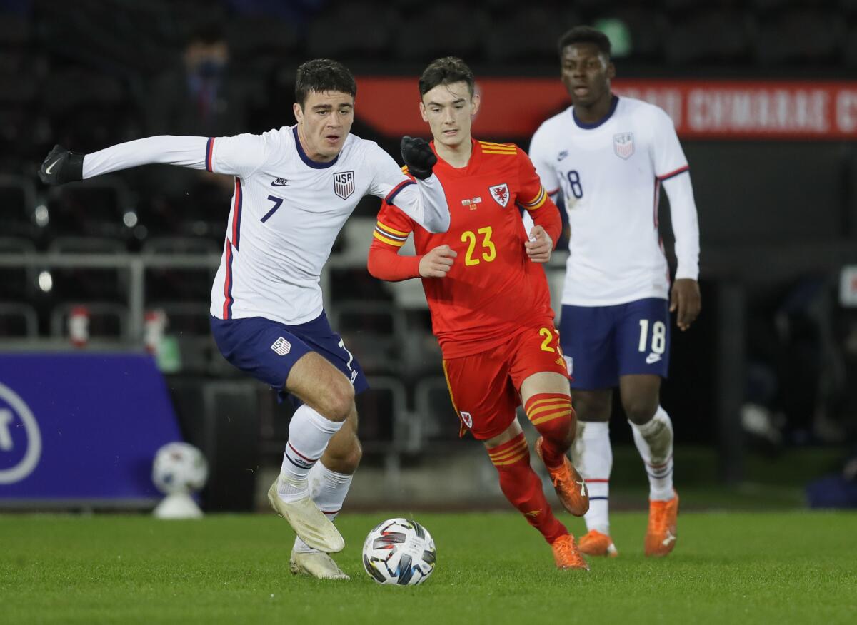 FILE - United States' Gio Reyna, left, vies for the ball with Wales' Dylan Levitt.