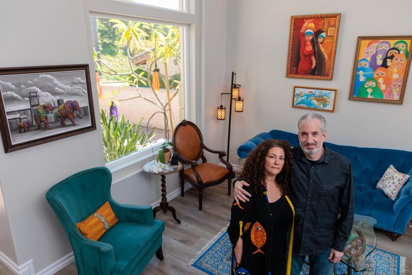 SAN DIEGO, CA - OCTOBER 10: In the days since Israel declared war after a devastating attack by Hamas, Lana Khoury, left, and Jon Greene, a Palestinian-Jewish couple living in San Diego, have been processing the toll together. Lana Khoury and Jon Greene photographed on Tuesday, Oct. 10, 2023 at home in San Diego, CA. (Irfan Khan / Los Angeles Times)