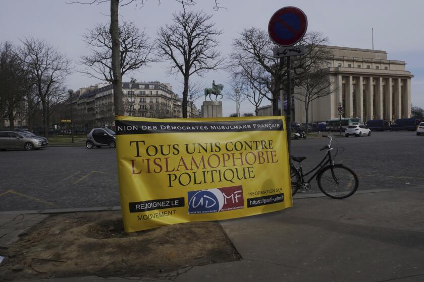 A banner reads « All united against political islamophobia » during a gathering in Paris, Sunday, Feb. 14, 2021. Activists rallied Sunday in Paris to demand that the French government abandon a bill aimed at rooting out Islamist extremism that the protesters say could trample on religious freedom and make all Muslims into potential suspects. (AP Photo/Thibault Camus)