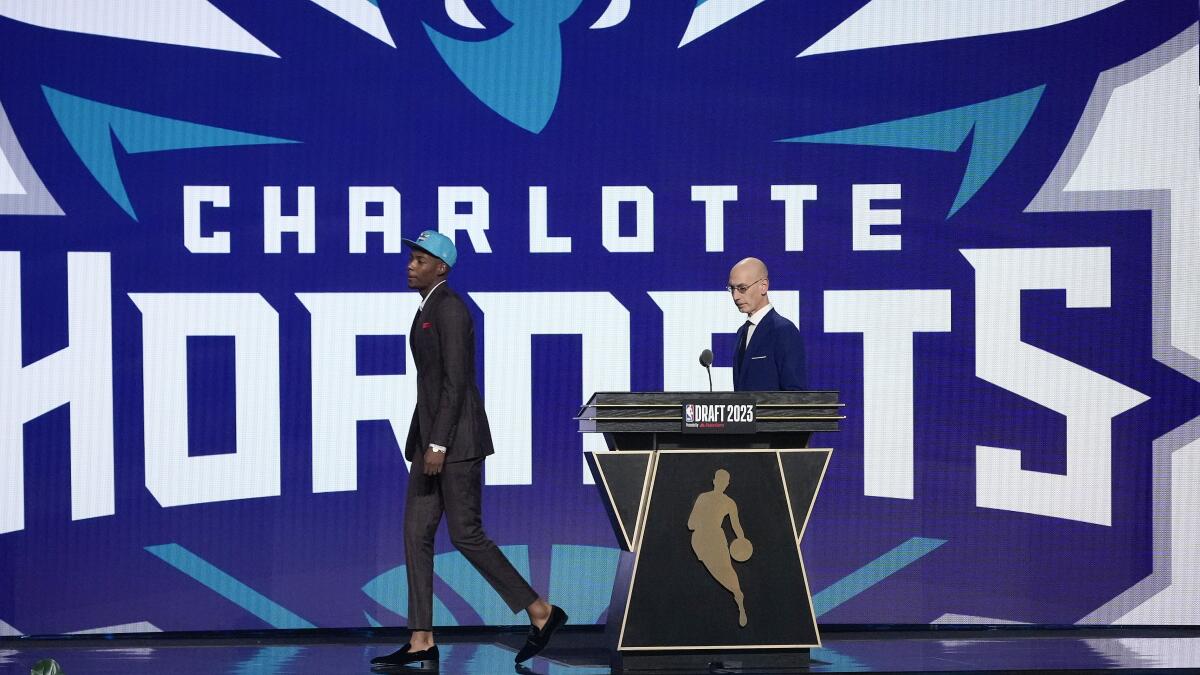 Brandon Miller walks off the stage after being selected second overall by the Charlotte Hornets.