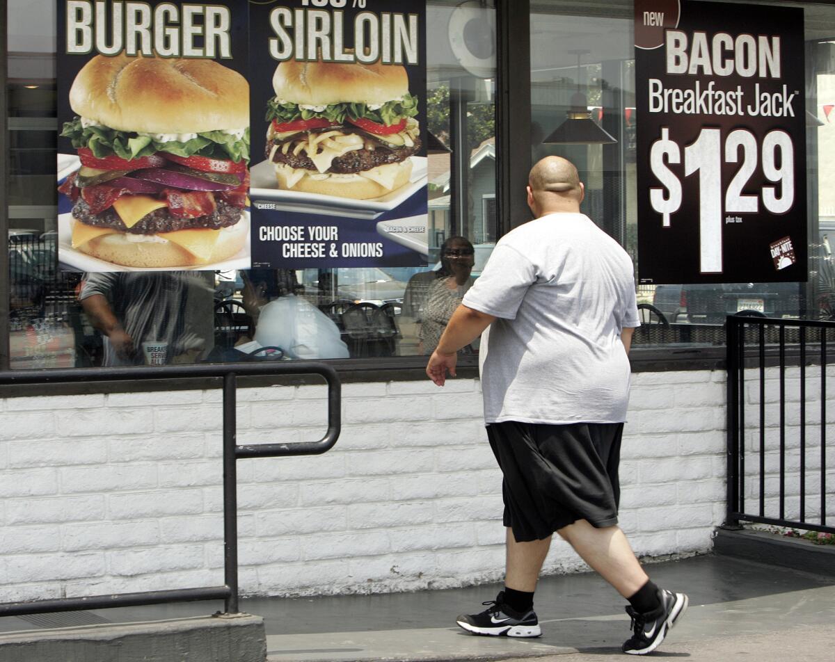 A customer makes his way into a Jack In The Box restaurant on Figueroa Street in South Los Angeles.