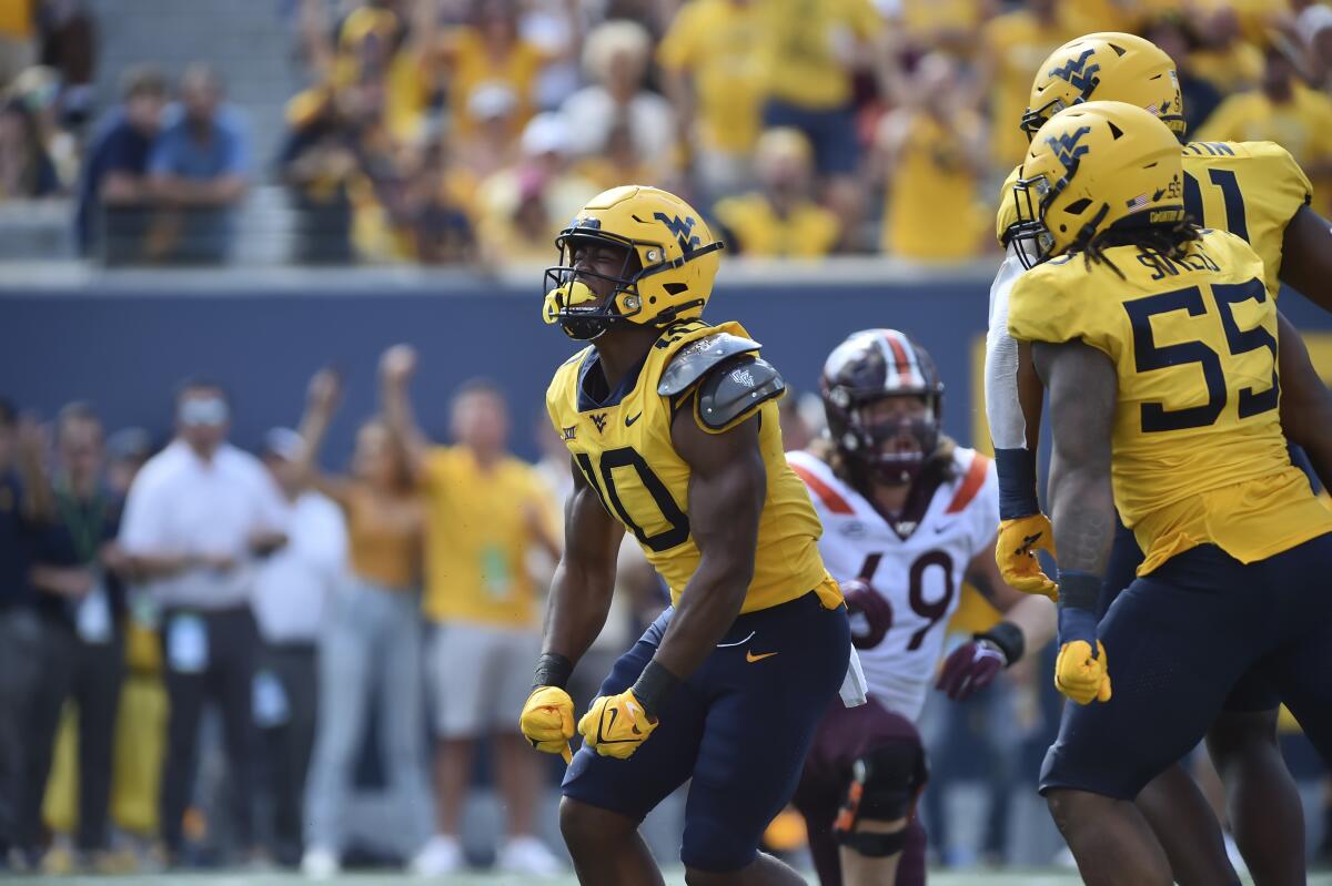 West Virginia linebacker Jared Bartlett (10) reacts after sacking Virginia Tech's Braxton Burmeister on Sept. 18, 2021.