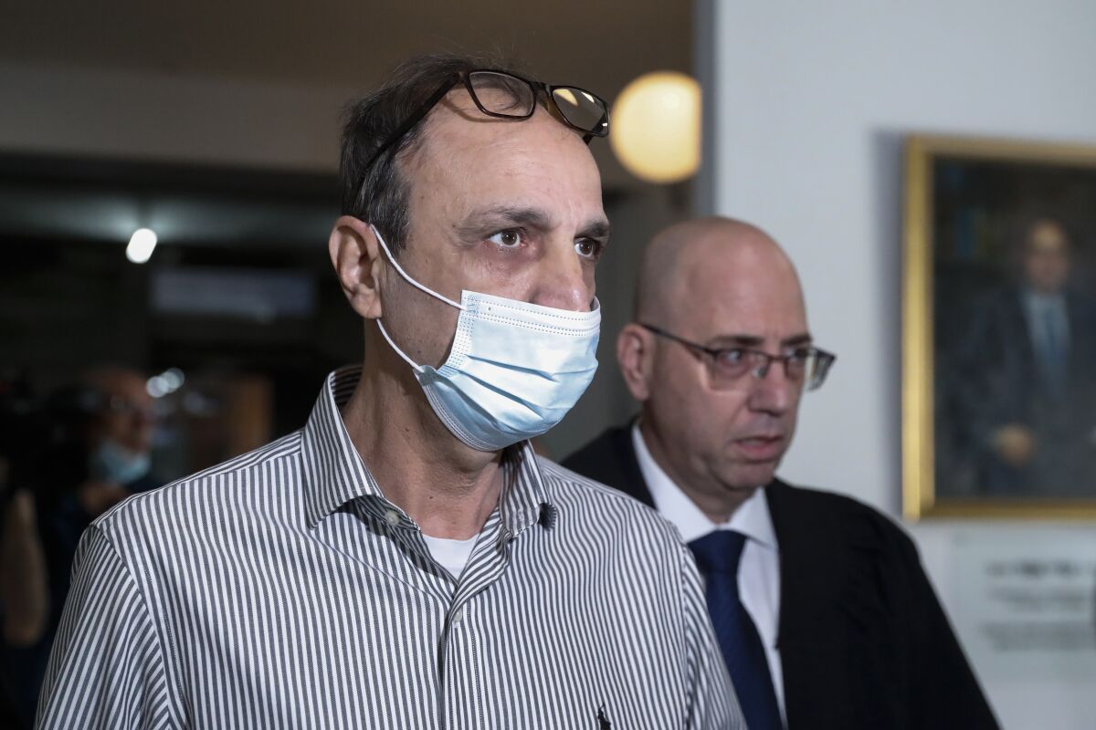 Shmulik Peleg, grandfather of Eitan Biran, who survived a cable car crash in Italy that killed his immediate family, arrives at court in Tel Aviv, Thursday, Nov. 11, 2021. (AP Photo/Ariel Schalit)