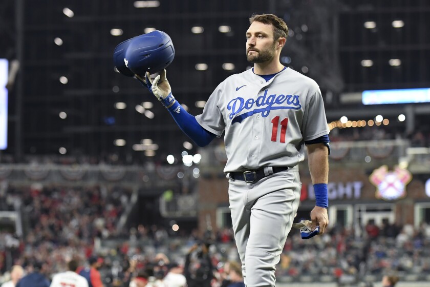 Los Angeles Dodgers' AJ Pollock tosses his helmet after grounding out