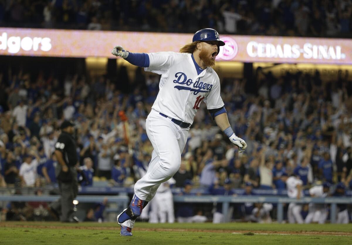 Justin Turner celebrates after hitting his a home run off San Francisco's Madison Bumgarner on Sept. 23.