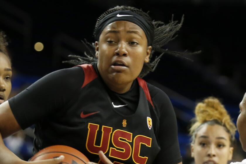 LOS ANGELES, CALIF. -- SUNDAY, DECEMBER 29, 2019: USC Trojans center Angel Jackson (15) drives to the basket guarded by UCLA Bruins guard Charisma Osborne (20) in the first half at Pauley Pavilion in Los Angeles, Calif., on Dec. 29, 2019. (Gary Coronado / Los Angeles Times)